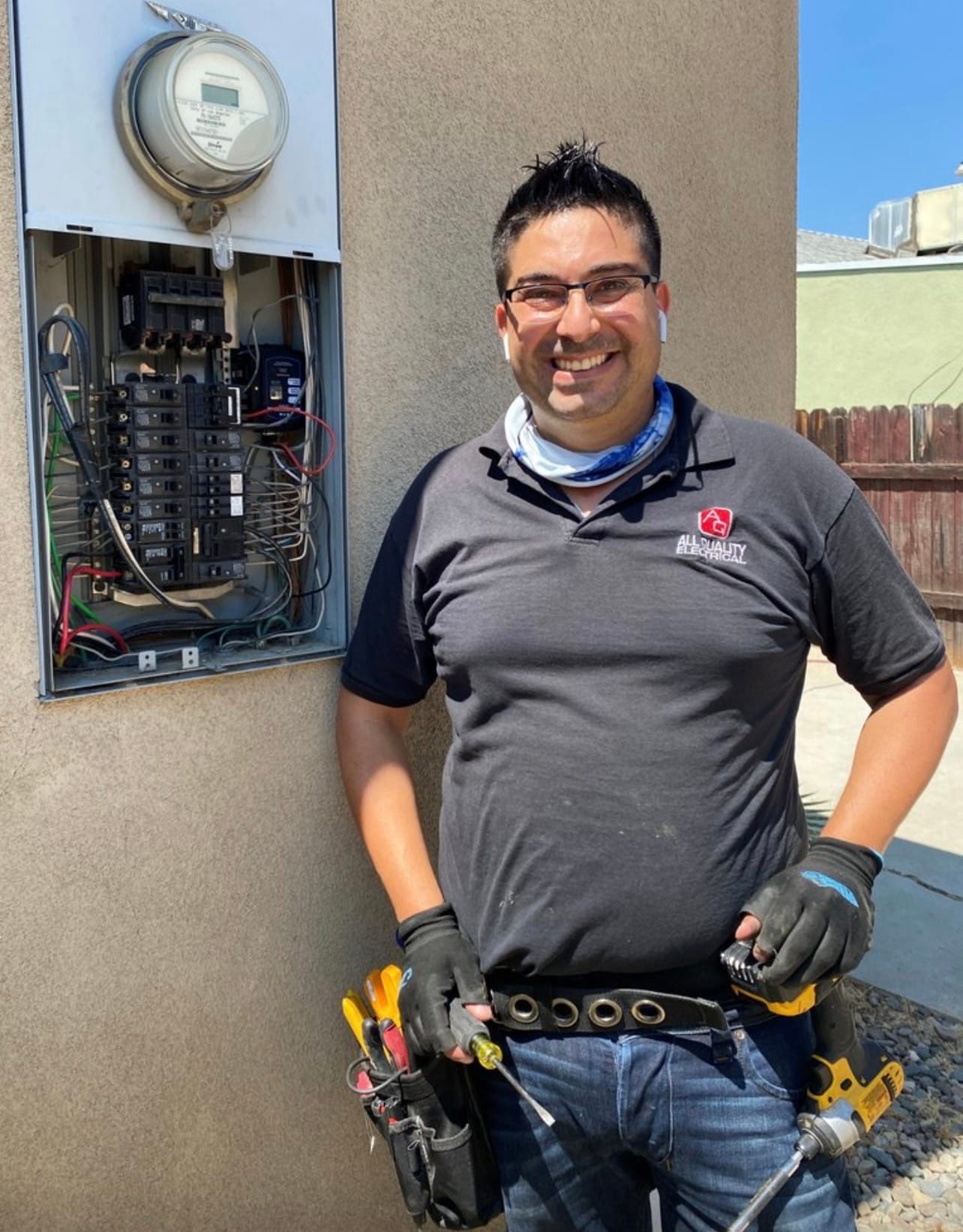 AQE technician next to a residential meter panel