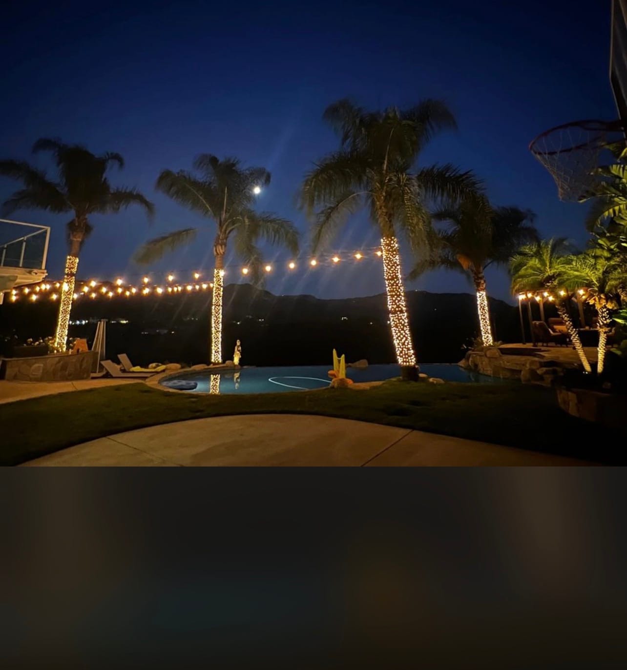 Poolside string lights and tree lighting at night